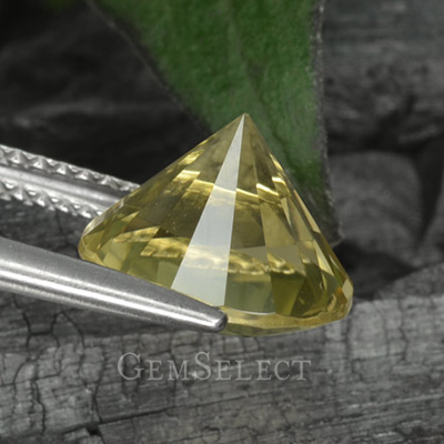 A Diamond-Cut Lemon Quartz Gem Held by the Girdle